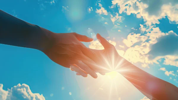 Hands reaching out to help each other in kindness
